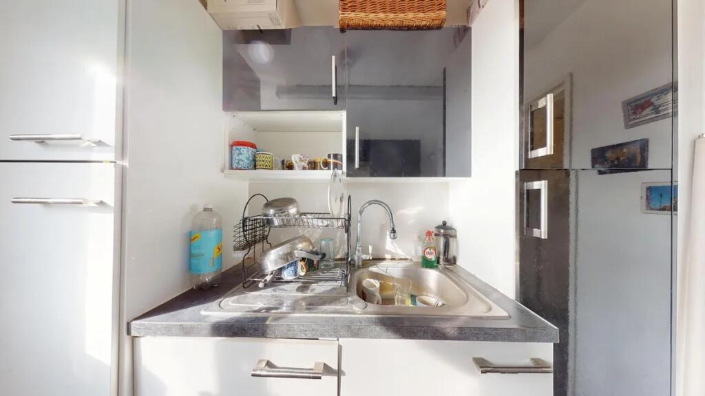 Bright and modern kitchen area featuring sleek ...