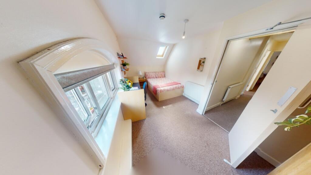 A bright and inviting double bedroom with ample...