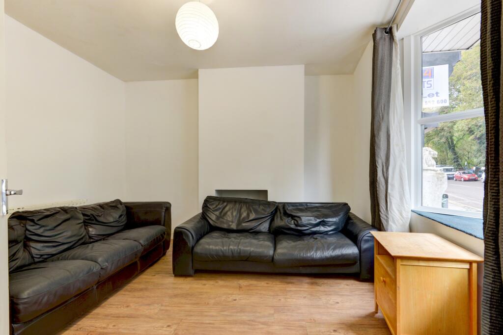 A comfortable living room featuring two black l...