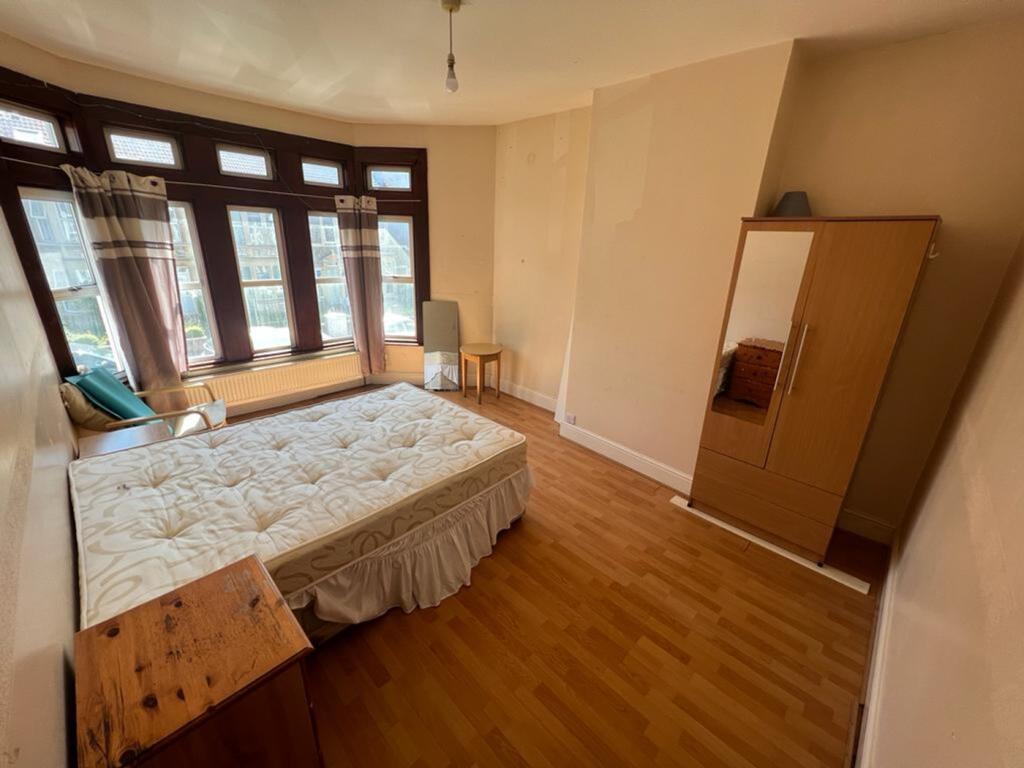 A spacious and bright double bedroom featuring ...