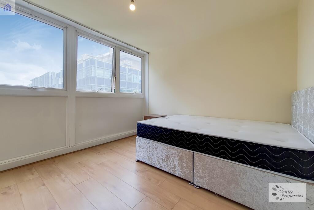 Bright and airy bedroom with large windows prov...