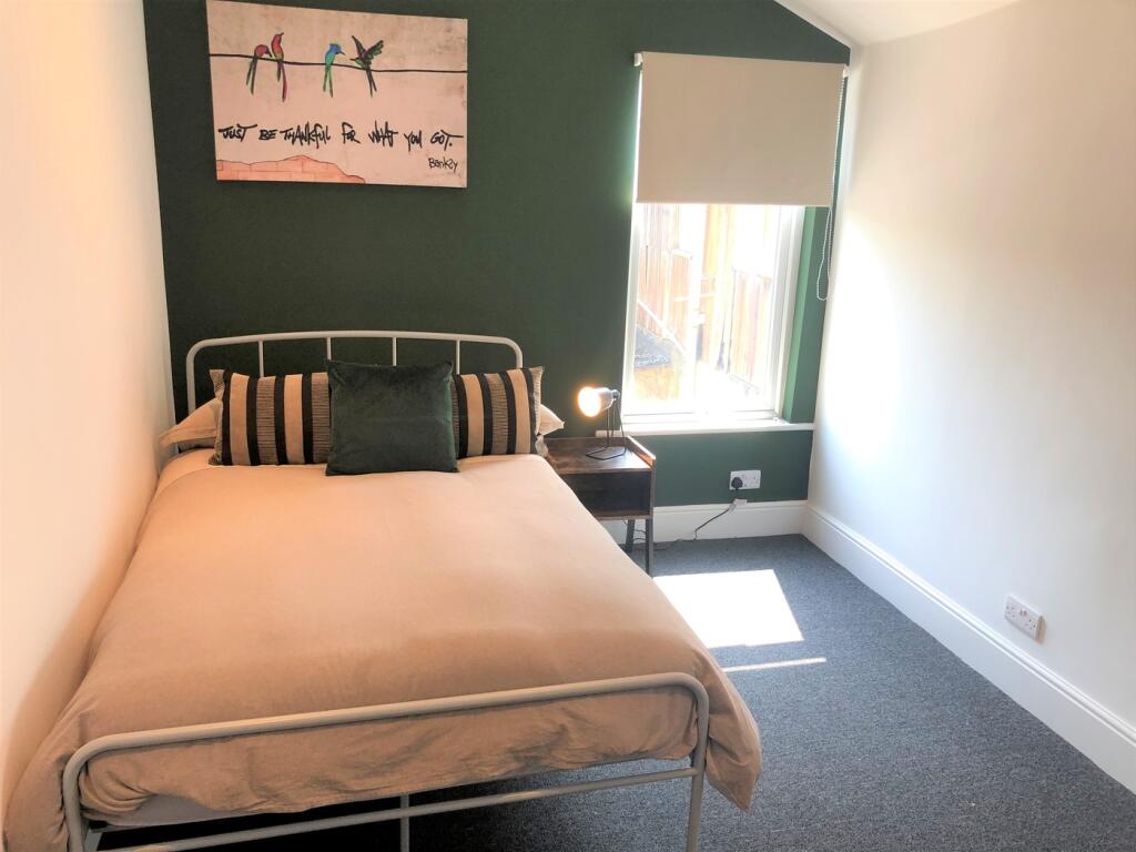 A bright and inviting double bedroom featuring ...