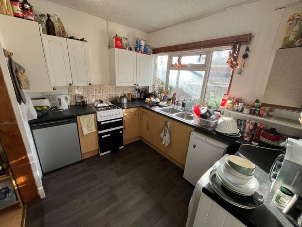 A cozy and functional kitchen with ample storag...
