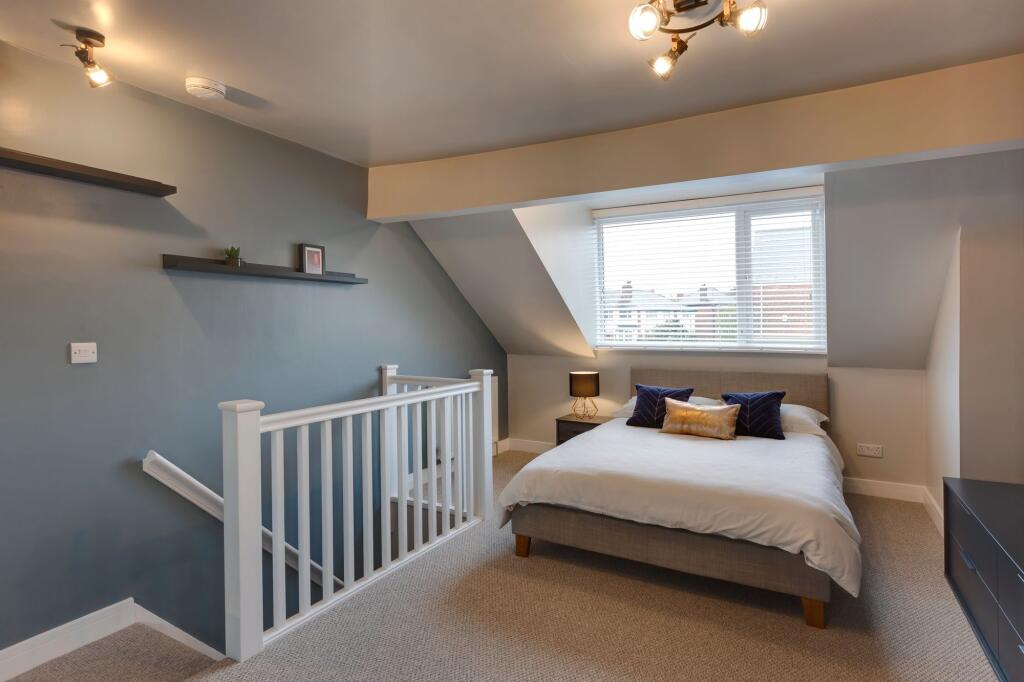Bright and spacious master bedroom featuring a ...