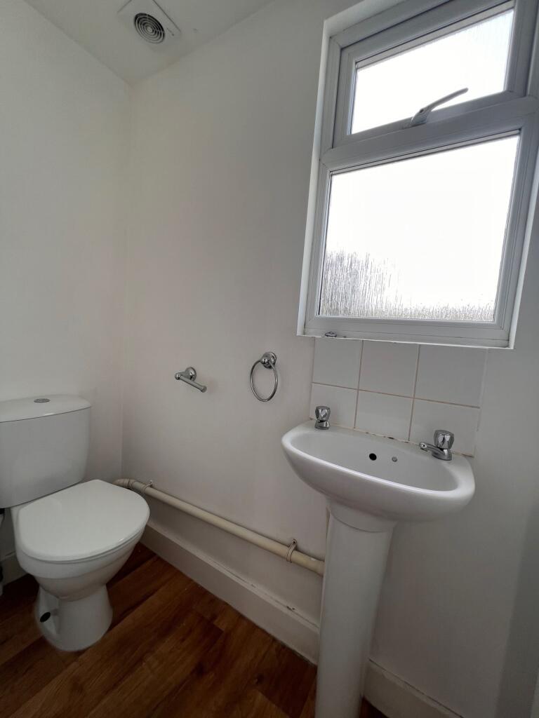 Bright and clean single toilet room featuring a...