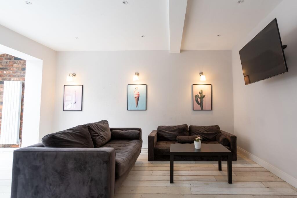 Contemporary living room with two comfortable d...