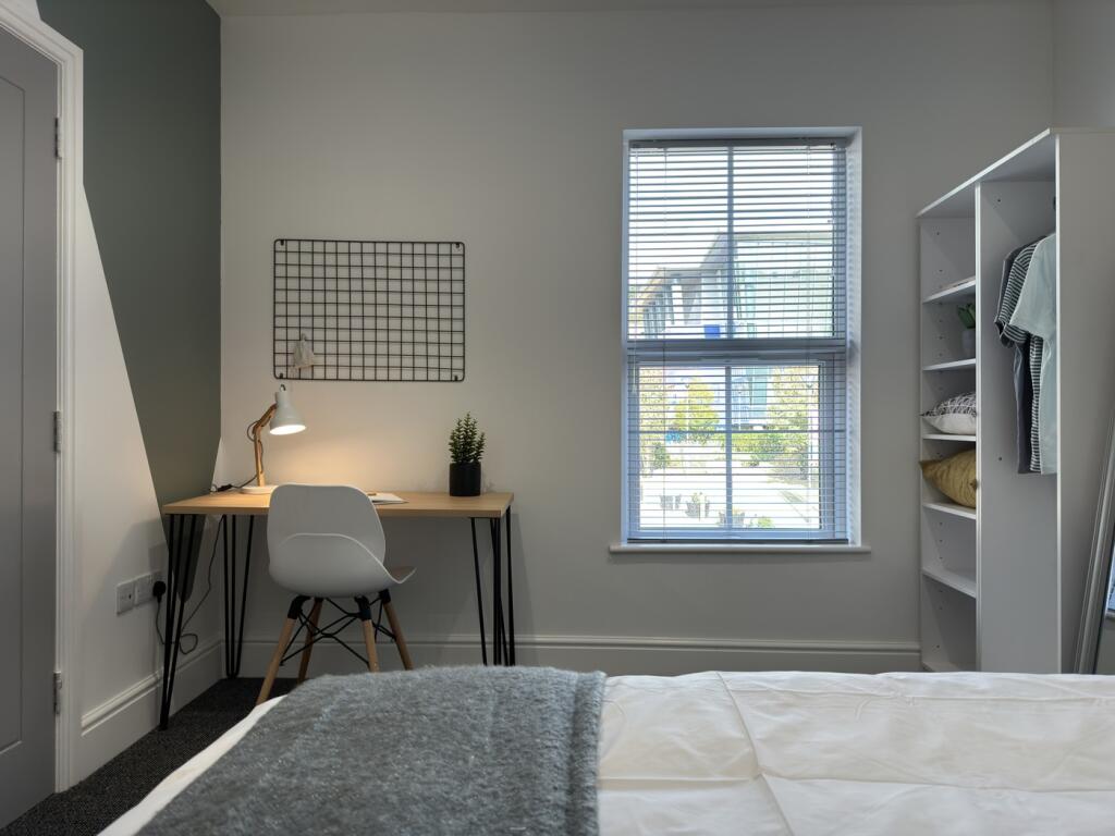 A bright and inviting double bedroom featuring ...