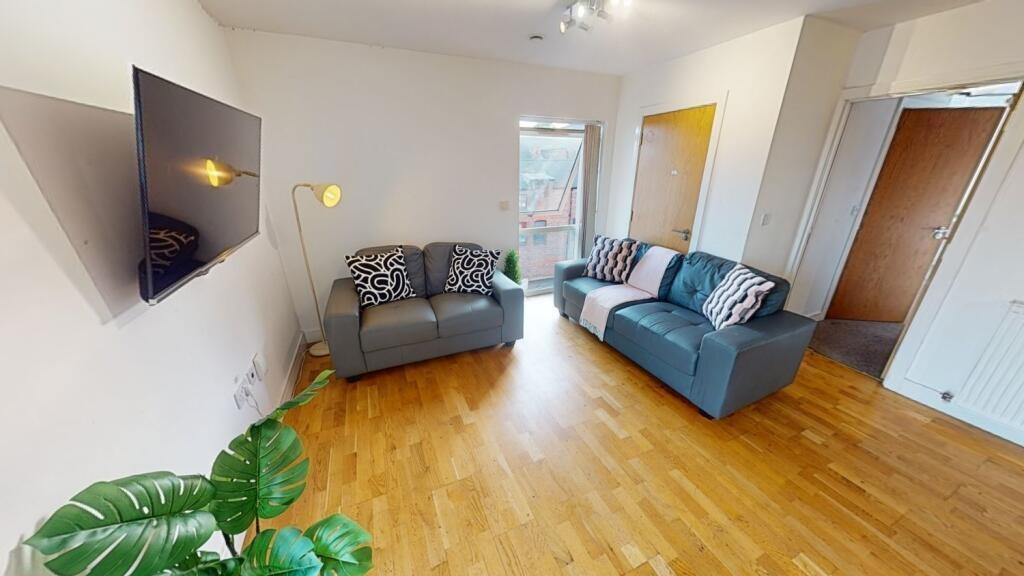 A bright and welcoming living room featuring mo...