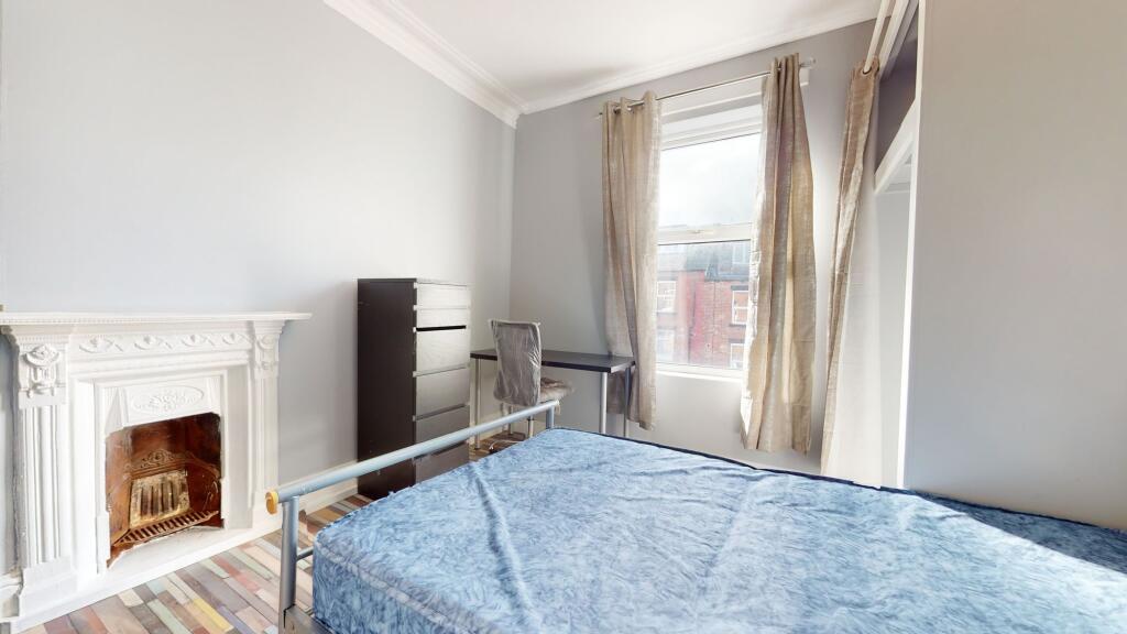 Bright and welcoming bedroom with a large windo...