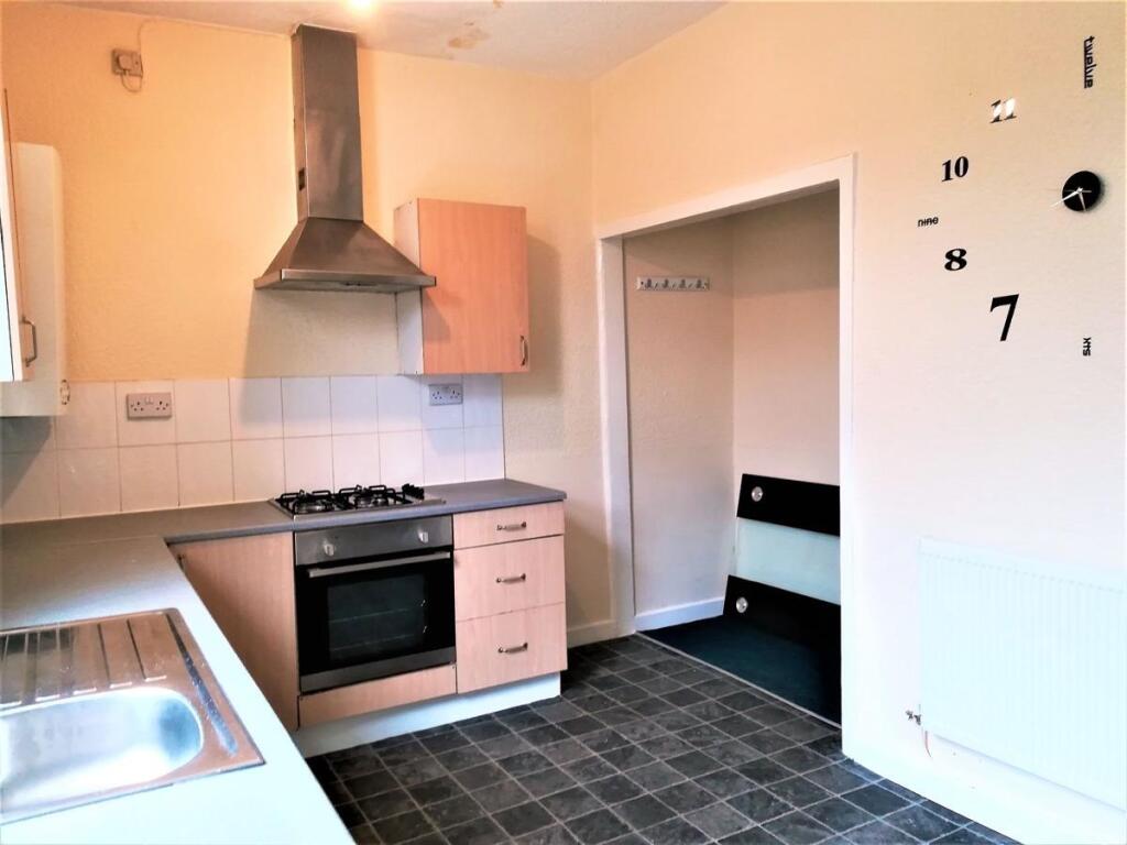 Bright kitchen with a stainless steel sink, gas...
