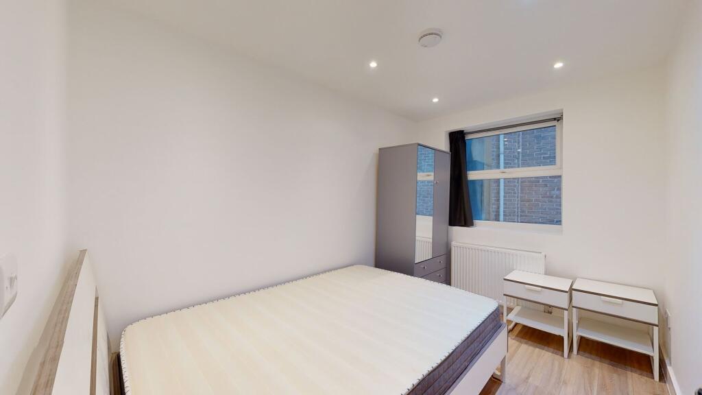 A neat and modern double bedroom featuring a co...