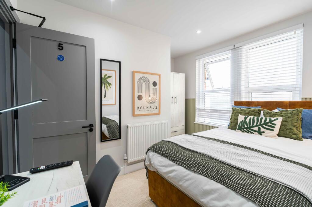 Bright and spacious master bedroom featuring a ...