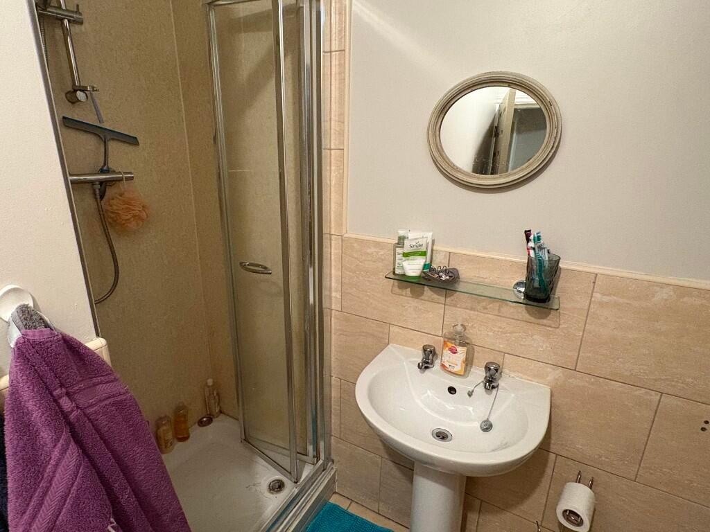 A clean and functional bathroom featuring a sho...