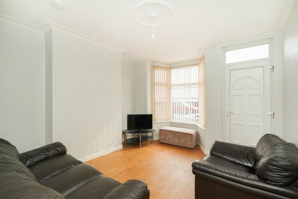 Bright and welcoming living room featuring comf...