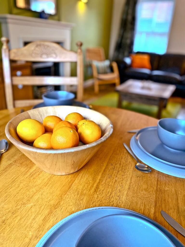 A cozy living room featuring a warm wooden dini...