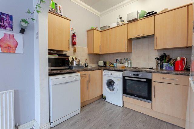 Bright and functional kitchen with modern cabin...