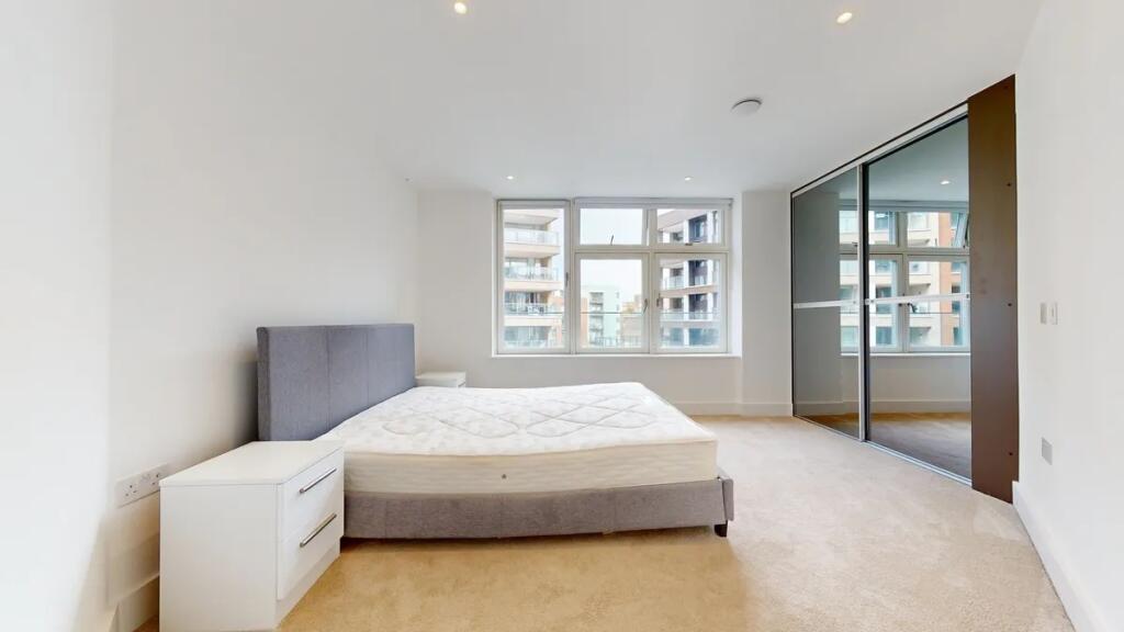 Bright and spacious master bedroom featuring a ...